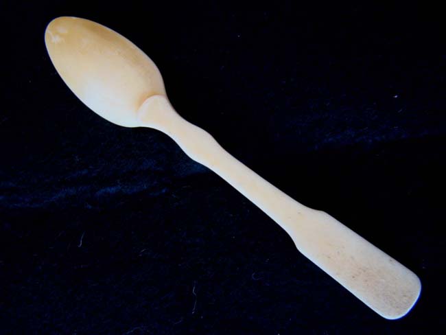 A single sailor carved bone 'fiddle' pattern teaspoon circa 1820-1850